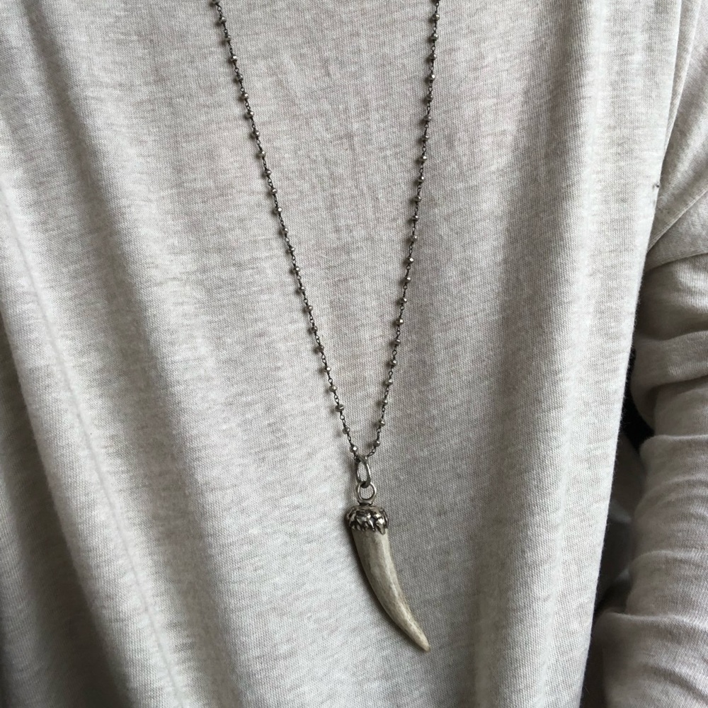 gray beaded necklace with bone horn charm
